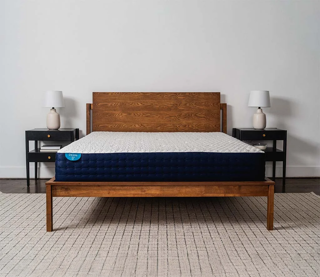 Tochta Utopia mattress with blue sides on a wooden bed frame